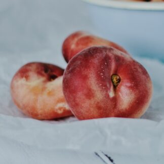 red apples on white ceramic bowl