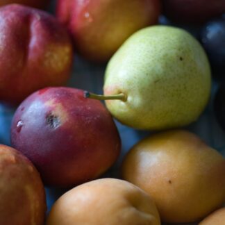 Various types of fresh, ripe fruit are piled together.